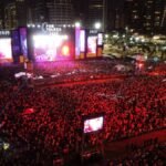 Vista aérea do Réveillon no Aterro da Praia de Iracema, em Fortaleza, com mais de um milhão de pessoas celebrando a virada de 2024 para 2025.